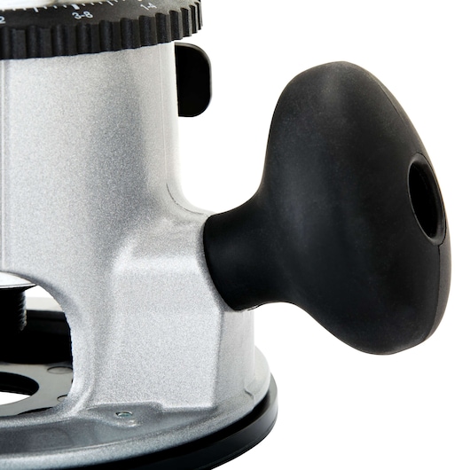 Close-up view of a PORTER-CABLE router, showing the side handle made of black plastic and part of the metallic body with adjustment markings.