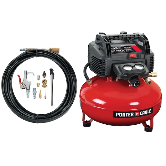 PORTER-CABLE air compressor kit, SKU C2002-WK, includes a red pancake-style air compressor, coiled hose, and assorted accessories such as connectors, nozzle, and air tool. All items are arranged on a white background.