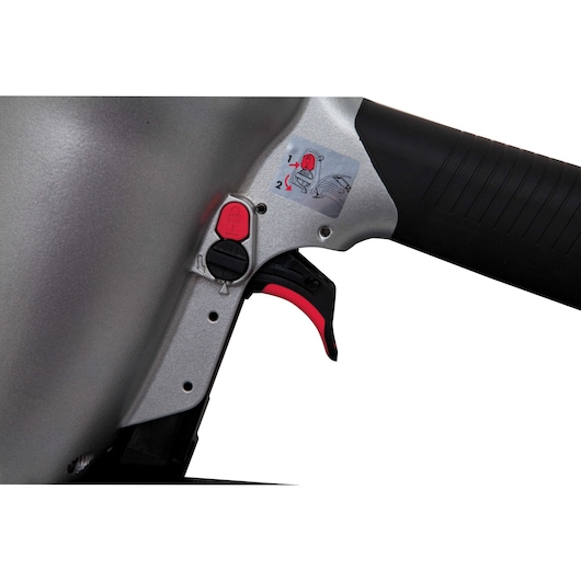 Close-up view of a PORTER-CABLE FR350B pneumatic framing nailer, showing the trigger, handle, and safety lock mechanism with instructional sticker.