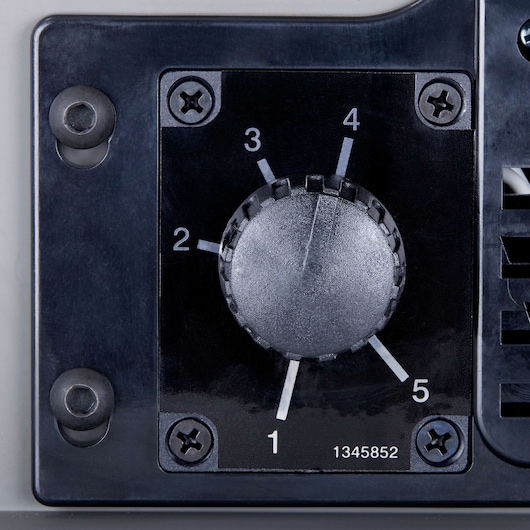 Close-up view of a black control knob with numbered settings from 1 to 5, mounted on a device with visible screws at each corner.