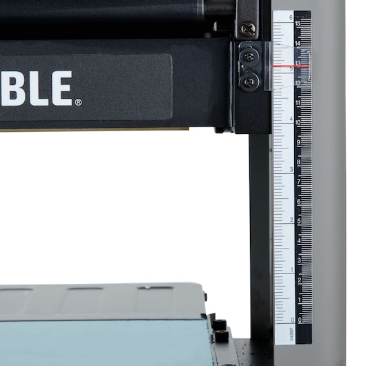 Close-up of a PORTER-CABLE PC305TP machine showing a measurement scale on the side, with part of the brand name visible.