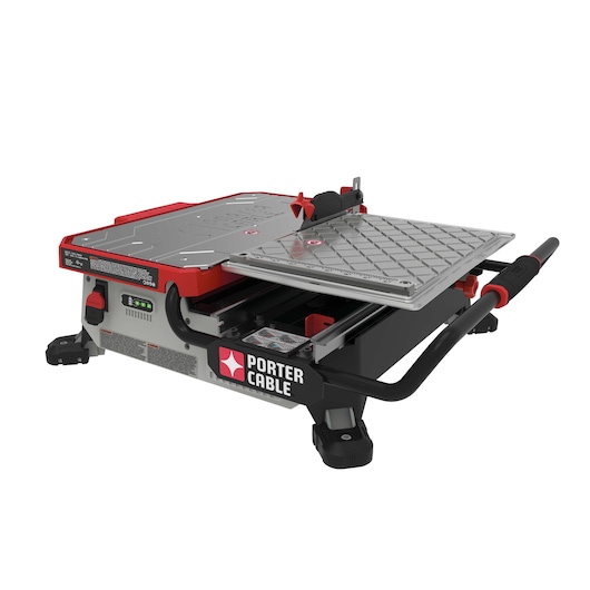 A PORTER-CABLE branded tabletop electric tile saw with a metal cutting surface, adjustable guide, and water reservoir. The tool has a compact design with red, silver, and black coloring and is intended for precise tile cutting.