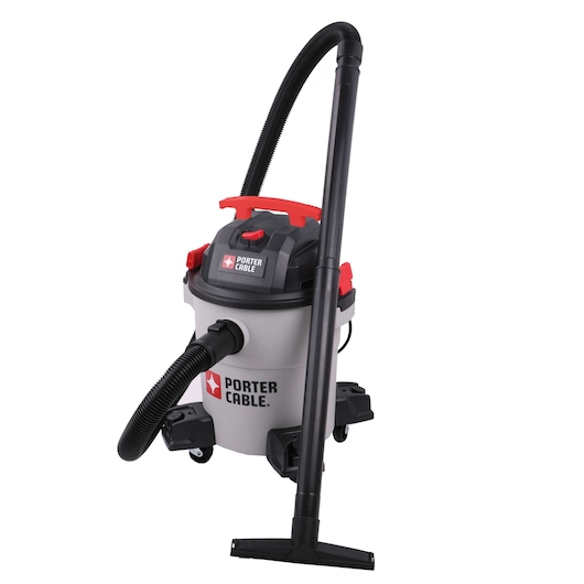 A PORTER-CABLE wet/dry vacuum cleaner with a cylindrical body, black hose, red and black top, and wheeled base. The vacuum is standing upright with its hose and extension tube attached.