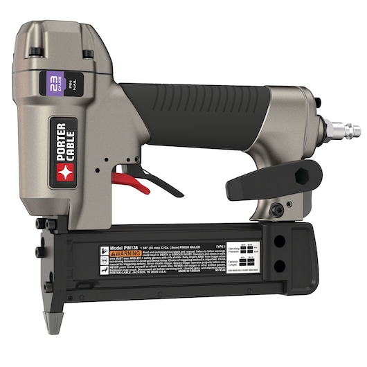 A PORTER-CABLE PIN138 23-gauge pin nailer tool with a gray and black body, red trigger, and visible brand label. The tool is designed for precision fastening and is used with compressed air. Warning and operational labels are shown on the lower part.