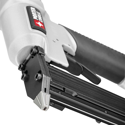 Close-up view of a PORTER-CABLE PIN138 pneumatic pin nailer tool, showing its metal body, handle grip, and the firing mechanism.